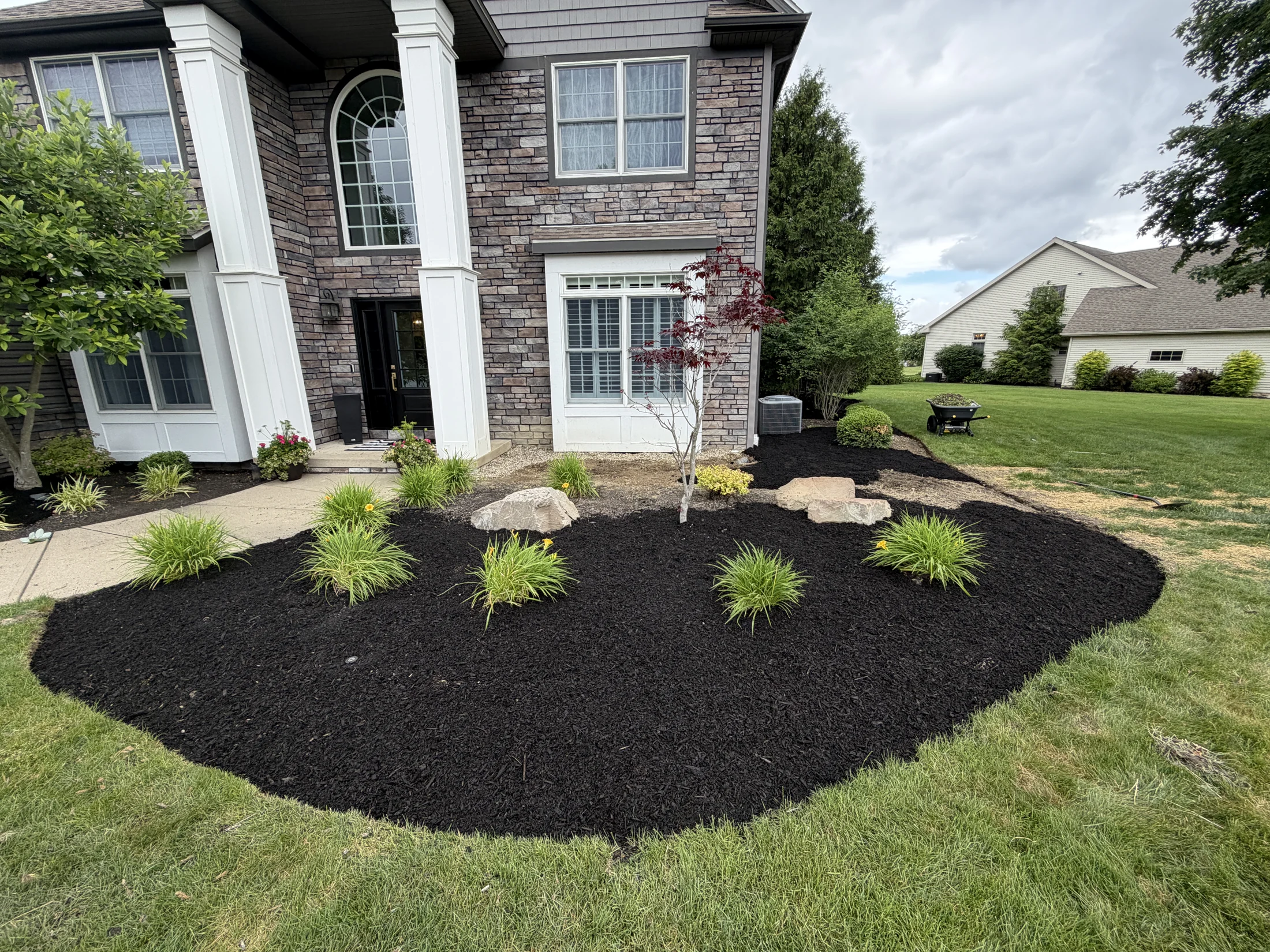 Fresh mulch and planting beds at a Grass Blasters project
