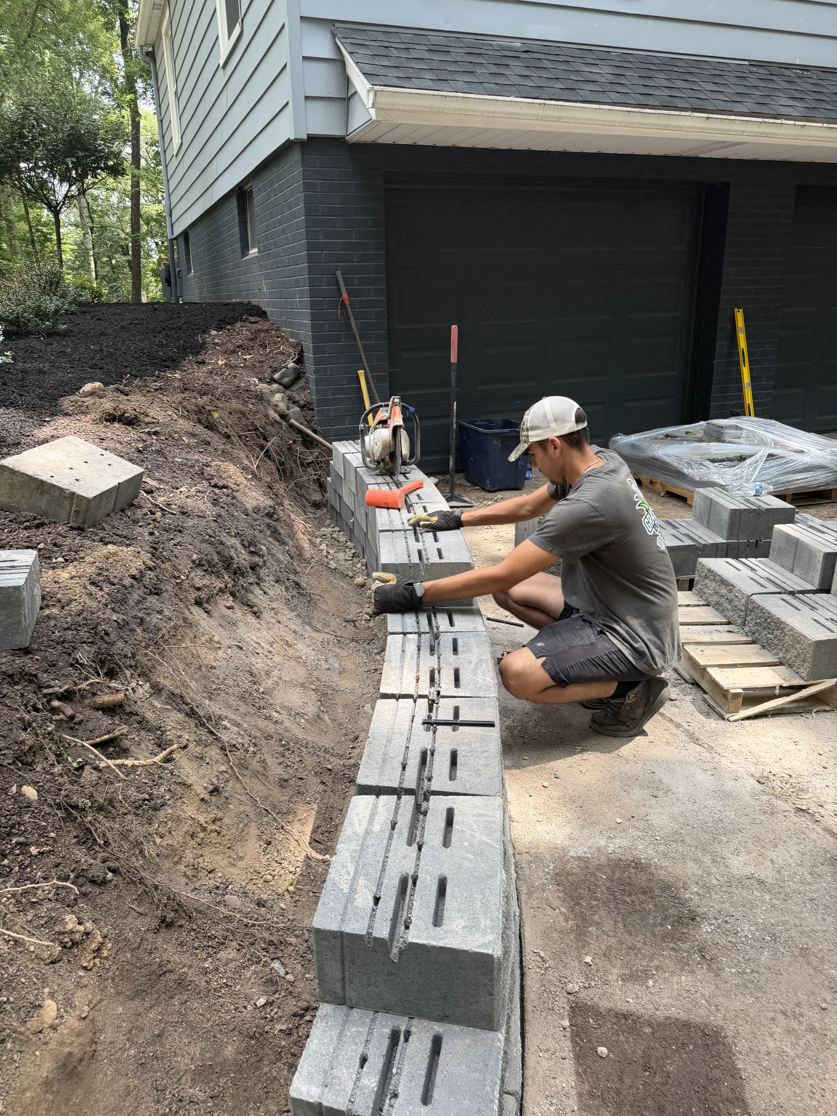 Grass Blasters crew member installing a retaining wall