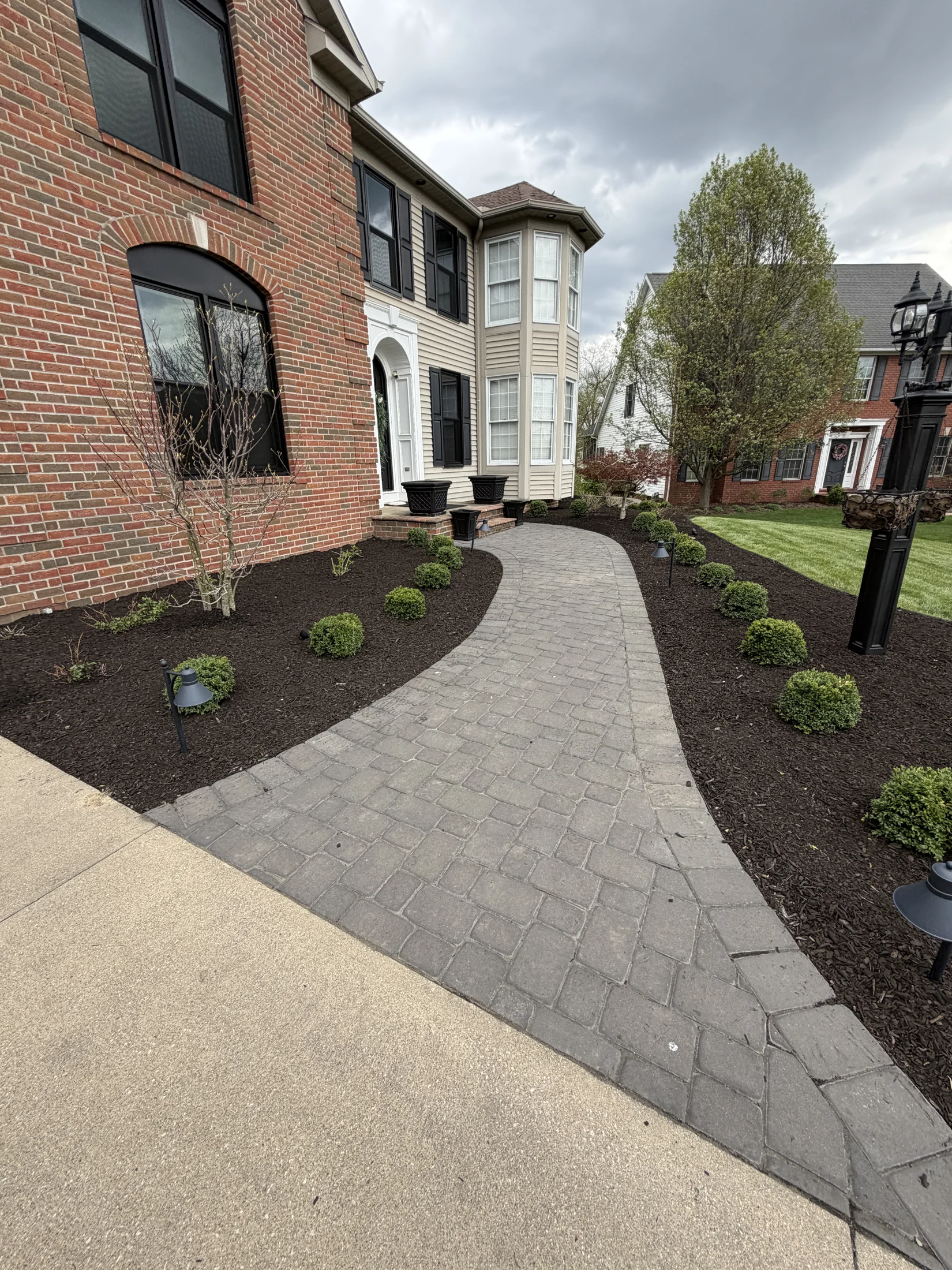 Freshly mulched beds beside a front walkway